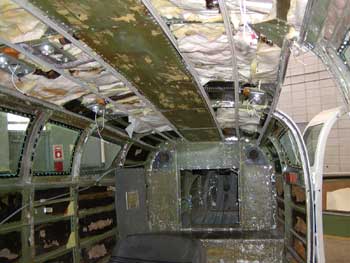 Gutted airplane interior in need of new headliner and more.