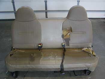 Damaged car seat in need of repair.