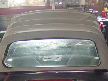 Damaged convertible top in need of repair.