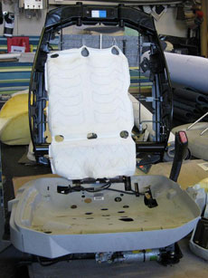 Seat with cushions in need of repair.