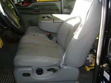 Seat with cushions in need of repair.