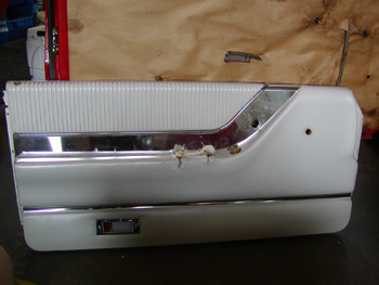 Thunderbird door panel in need of repair.